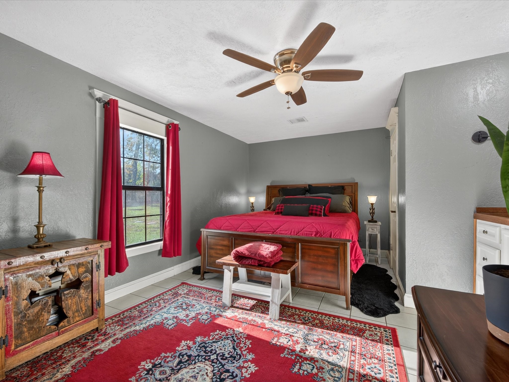 10277 Champion Forest Loop Conroe, TX 77303 - Photo 25 of 45 a bedroom with a bed and a chandelier