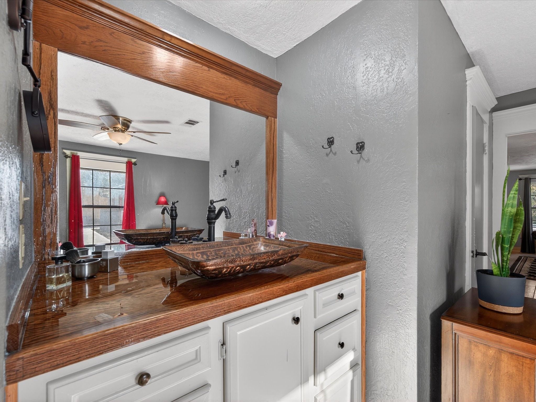 10277 Champion Forest Loop Conroe, TX 77303 - Photo 27 of 45 a bathroom with a sink and a mirror
