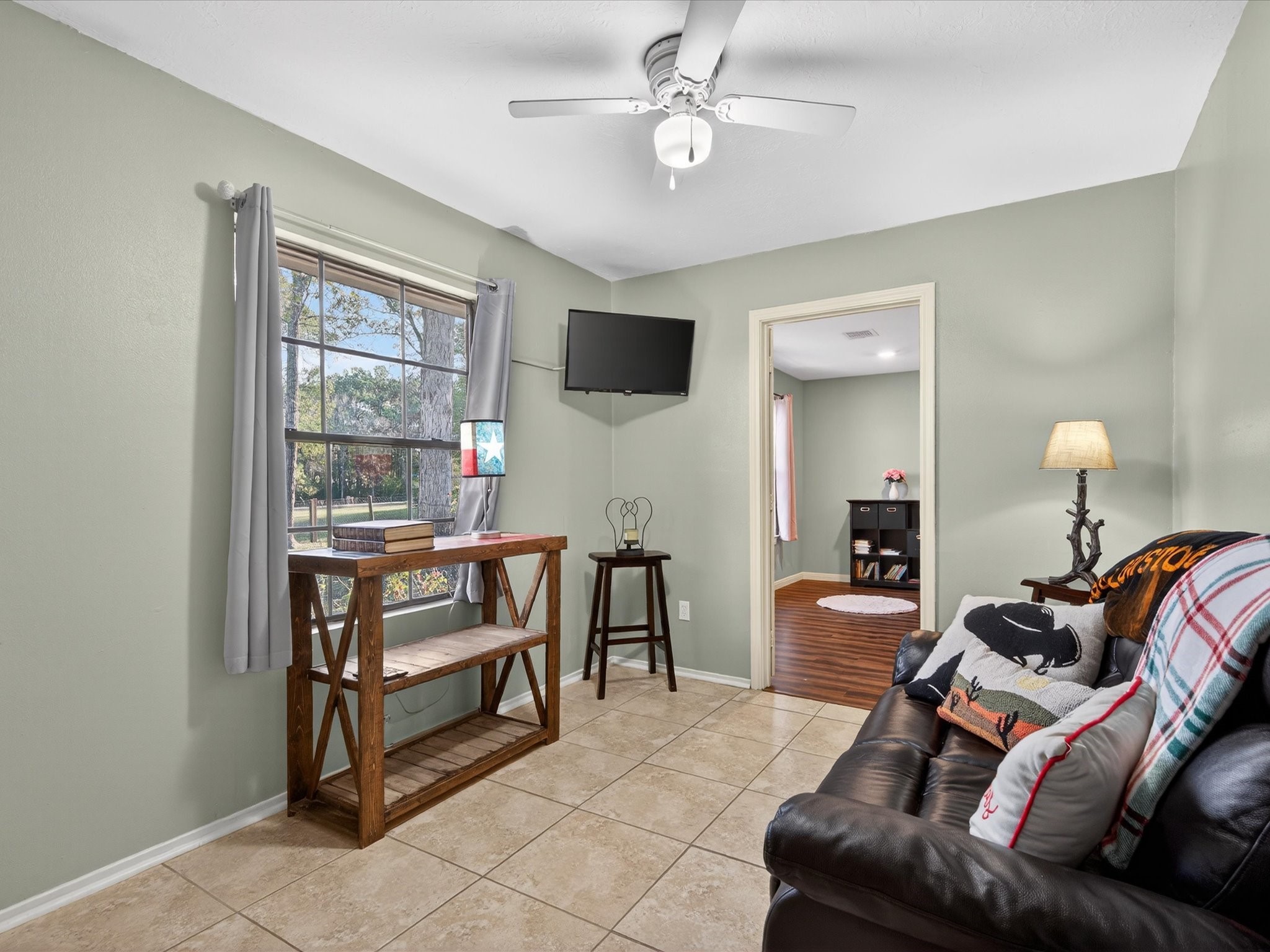 10277 Champion Forest Loop Conroe, TX 77303 - Photo 30 of 45 a living room with furniture and a flat screen tv