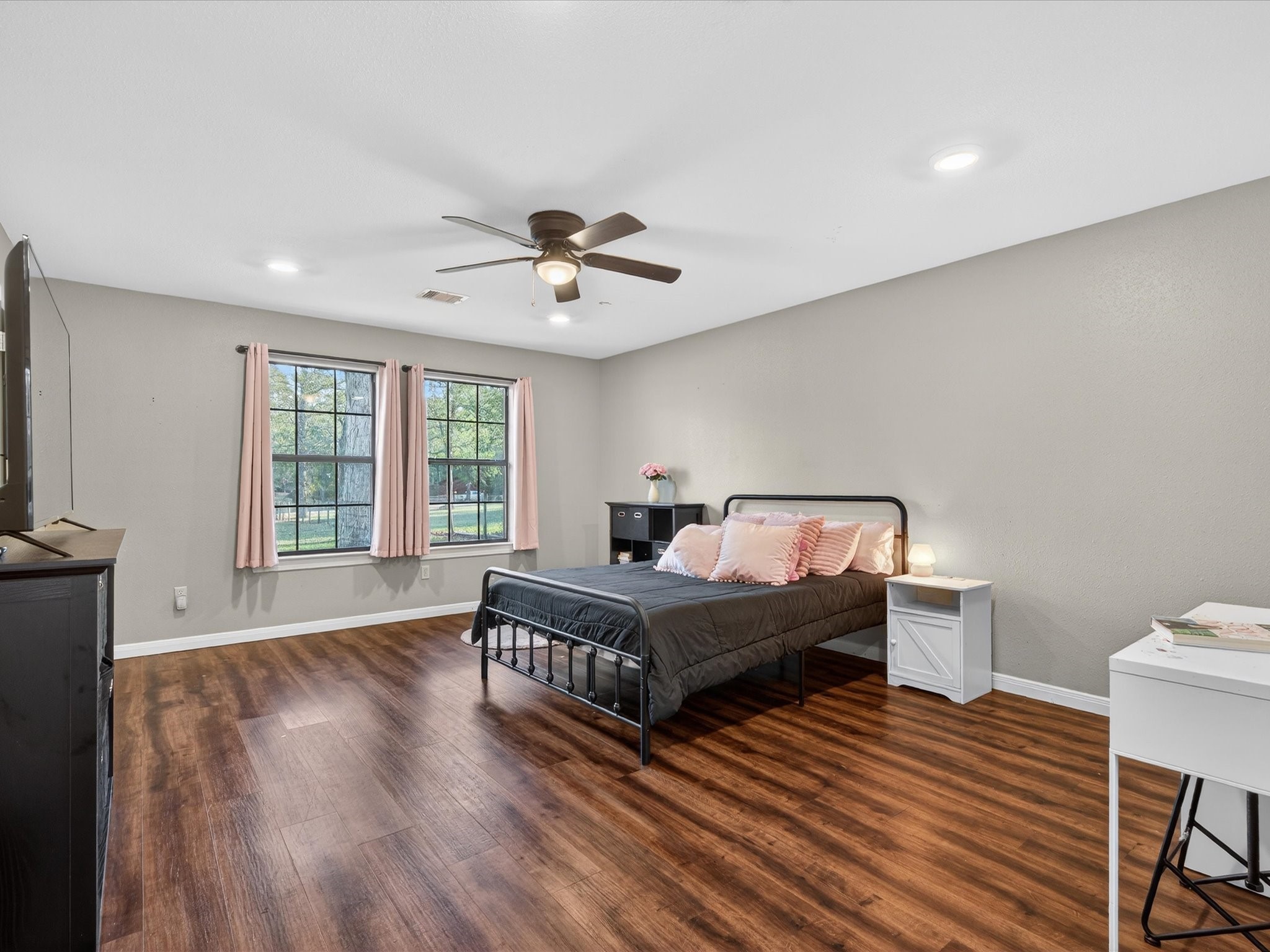 10277 Champion Forest Loop Conroe, TX 77303 - Photo 32 of 45 a spacious bedroom with a bed a chandelier and a window