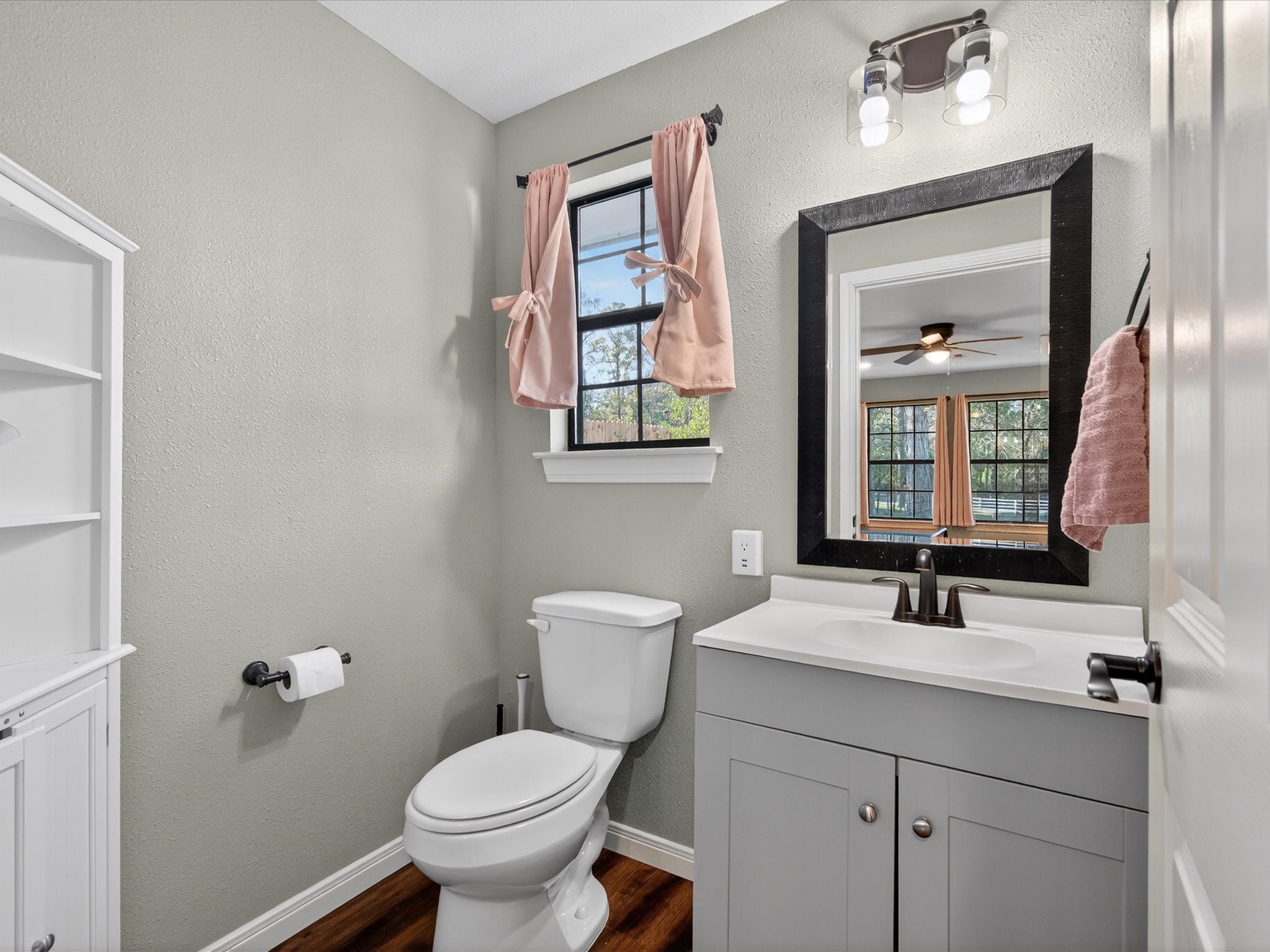 10277 Champion Forest Loop Conroe, TX 77303 - Photo 33 of 45 a bathroom with a toilet a sink and mirror