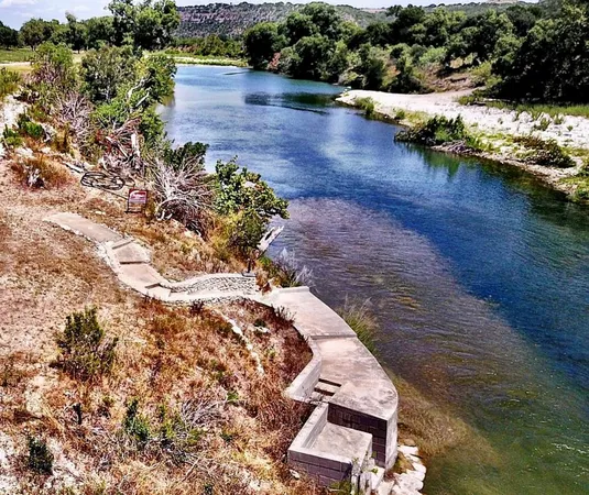 an aerial view of a house with a yard and lake view