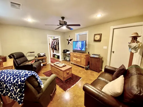 a living room with furniture ceiling fan and a rug