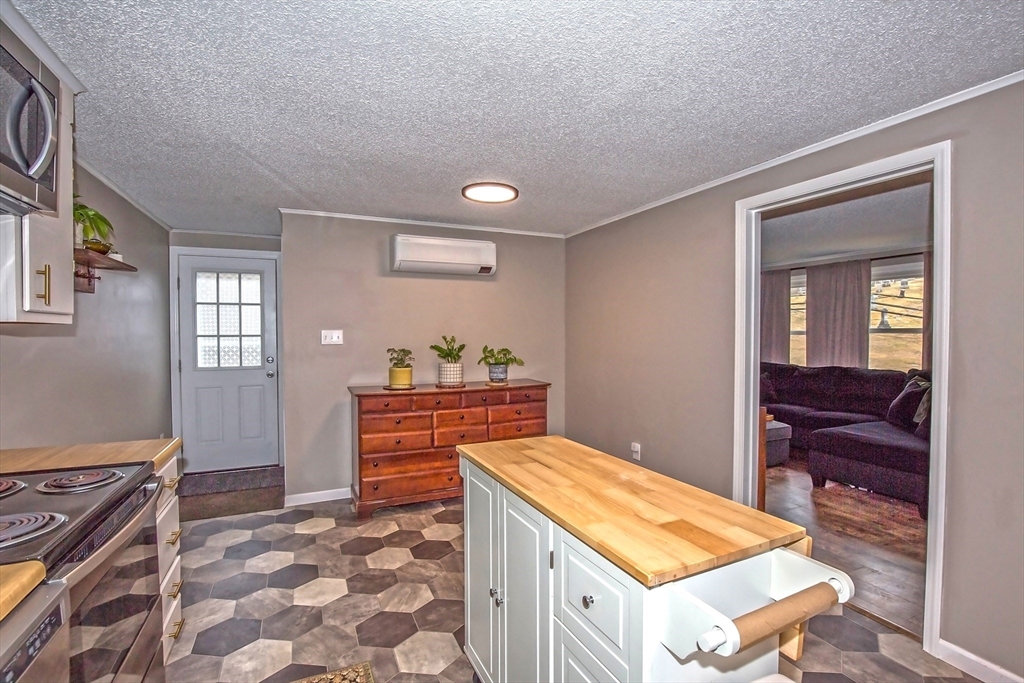4498 High Street Palmer, MA 01069 - Photo 11 of 26 a room with a bed and a dresser in it