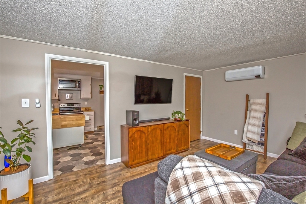 4498 High Street Palmer, MA 01069 - Photo 13 of 26 a bedroom with furniture and a flat screen tv