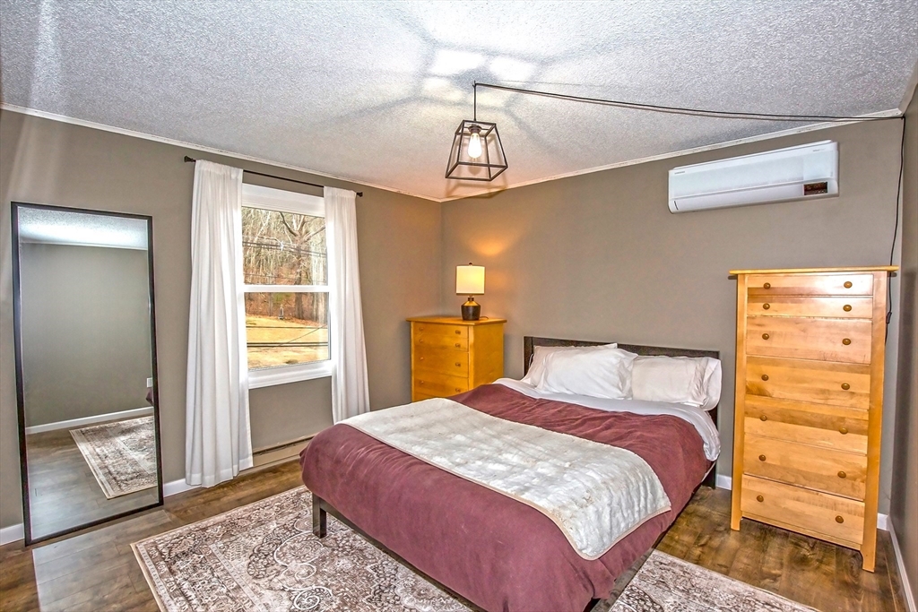 4498 High Street Palmer, MA 01069 - Photo 16 of 26 a bedroom with a bed and wooden floor