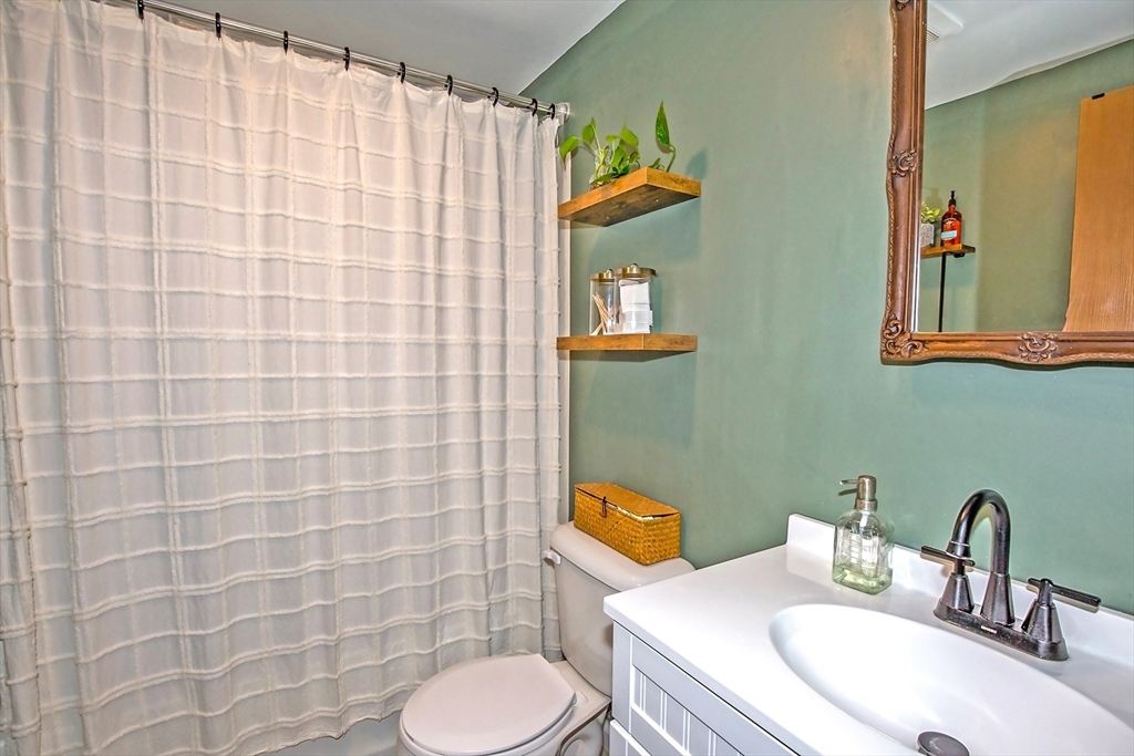 4498 High Street Palmer, MA 01069 - Photo 21 of 26 a bathroom with a sink a toilet and a mirror