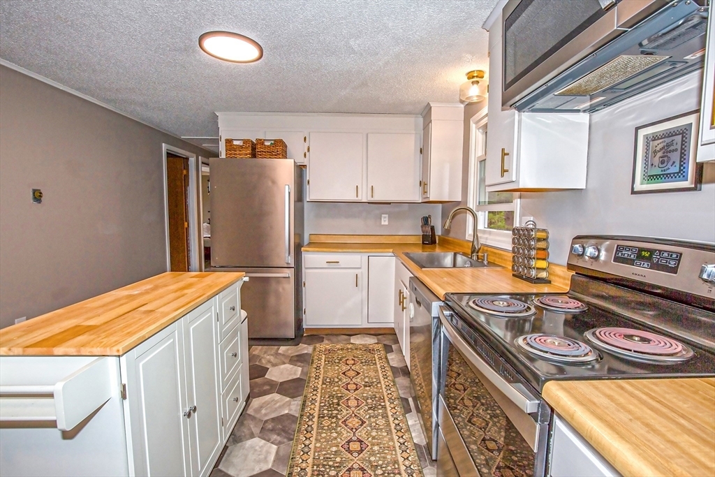 4498 High Street Palmer, MA 01069 - Photo 6 of 26 a kitchen that has a sink and a stove