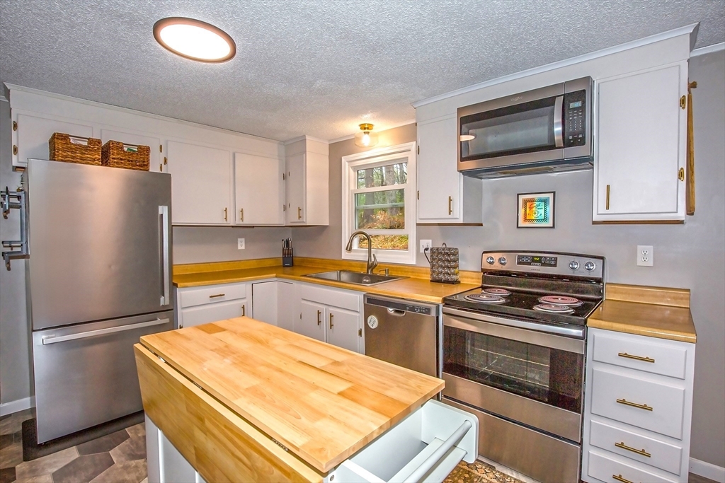 4498 High Street Palmer, MA 01069 - Photo 7 of 26 a kitchen with stainless steel appliances a refrigerator stove and sink