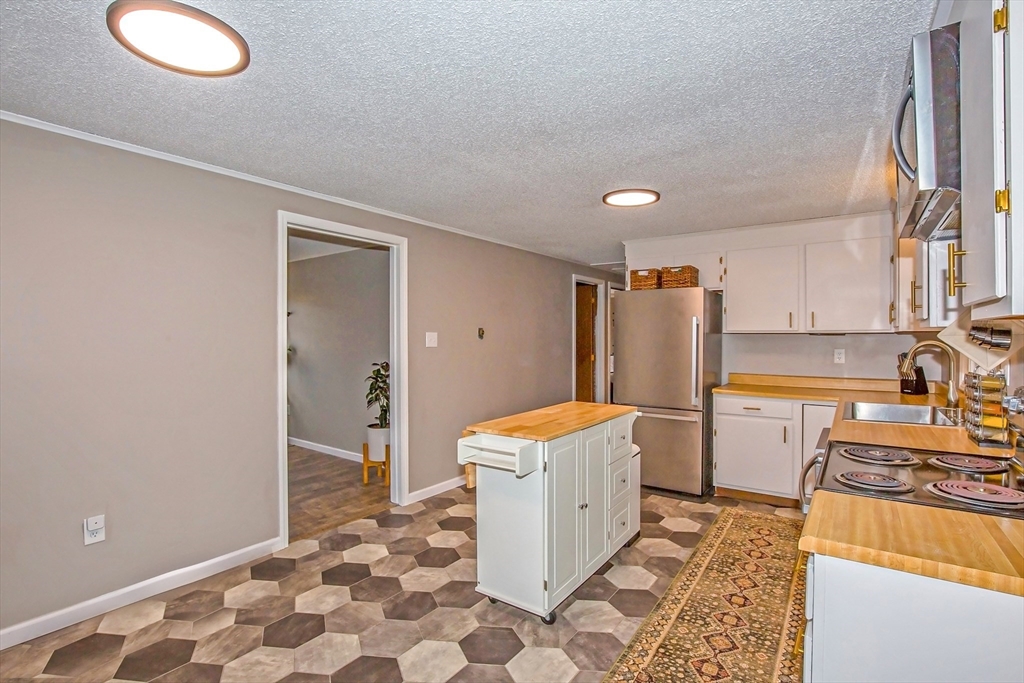 4498 High Street Palmer, MA 01069 - Photo 9 of 26 a room with a sink and a stove top oven