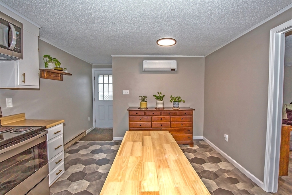 4498 High Street Palmer, MA 01069 - Photo 10 of 26 a bed room with a bed and a lamp on dresser