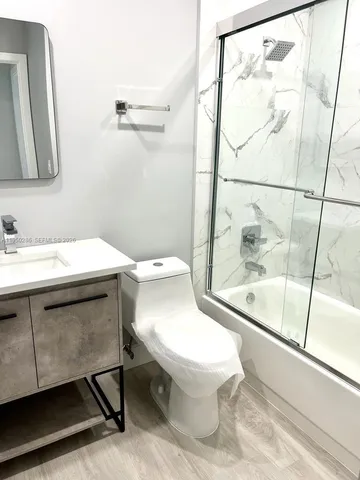 a bathroom with a sink toilet and a mirror