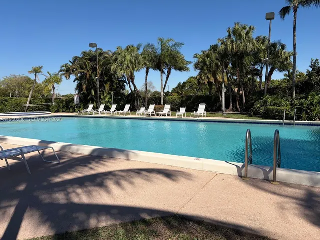 a view of a swimming pool and a yard