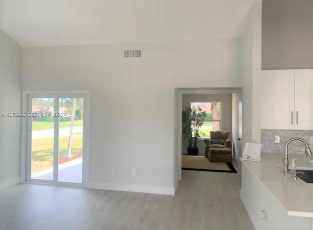 a view of a livingroom with a couch and a large window