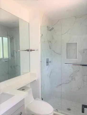 a bathroom with a sink toilet and shower