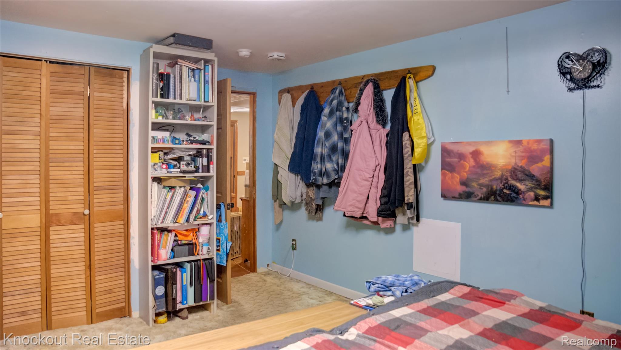 4195 Williamson Road Saginaw, MI 48601 - Photo 21 of 50 Bedroom featuring light blue walls, tan carpeting, and a wooden coat rack