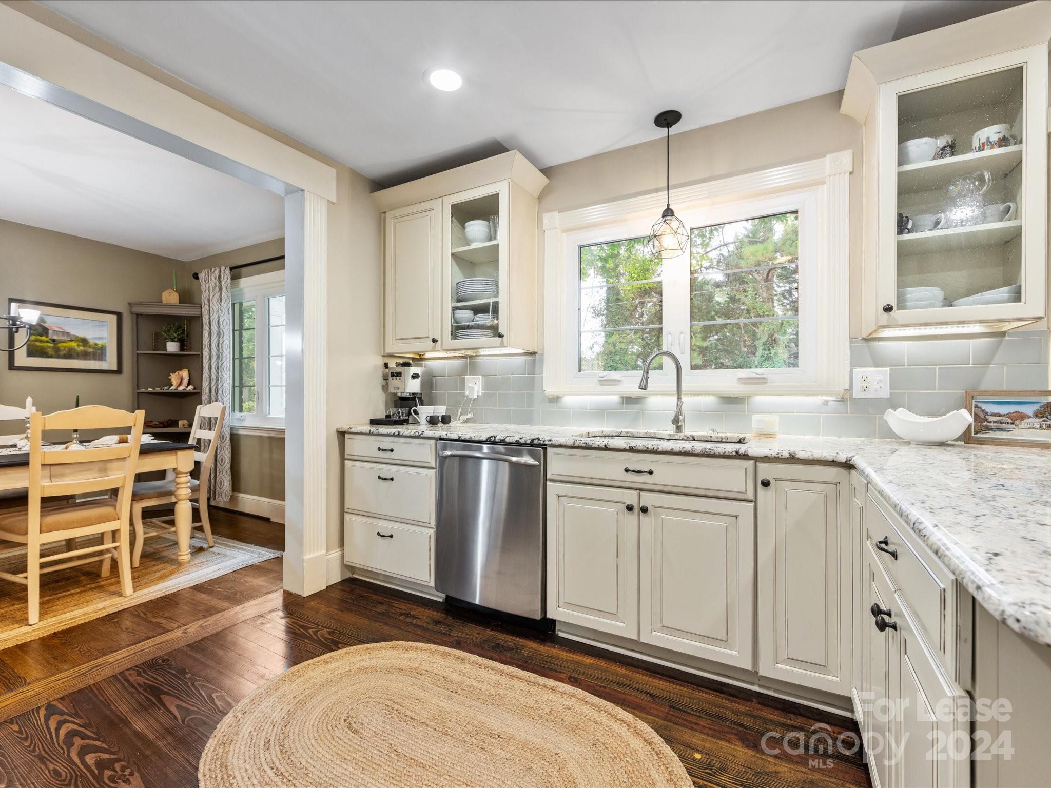 4411 Castleton Road Charlotte, NC 28211 - Photo 17 of 45 a kitchen with a sink stove and cabinets