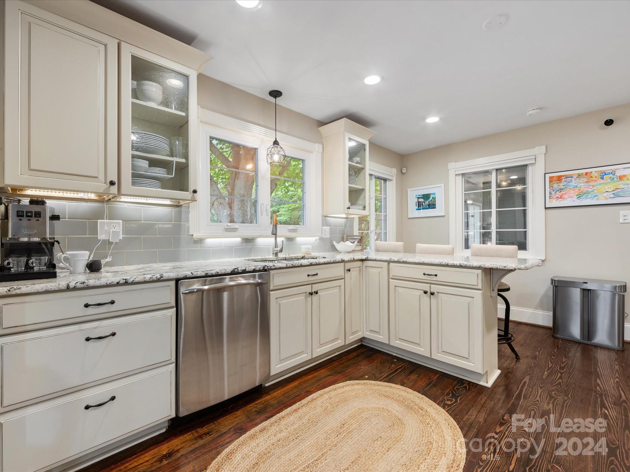 4411 Castleton Road Charlotte, NC 28211 - Photo 18 of 45 a kitchen with granite countertop cabinets stainless steel appliances a sink and a large window