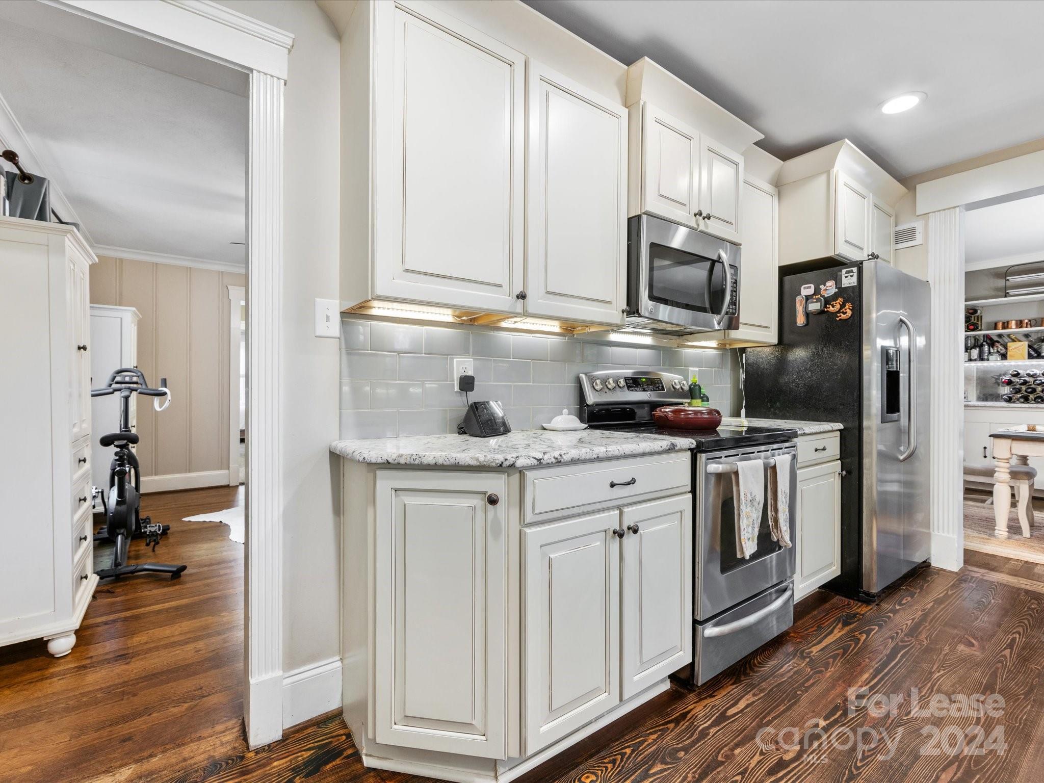 4411 Castleton Road Charlotte, NC 28211 - Photo 21 of 45 a kitchen with stainless steel appliances granite countertop a stove a sink and a refrigerator