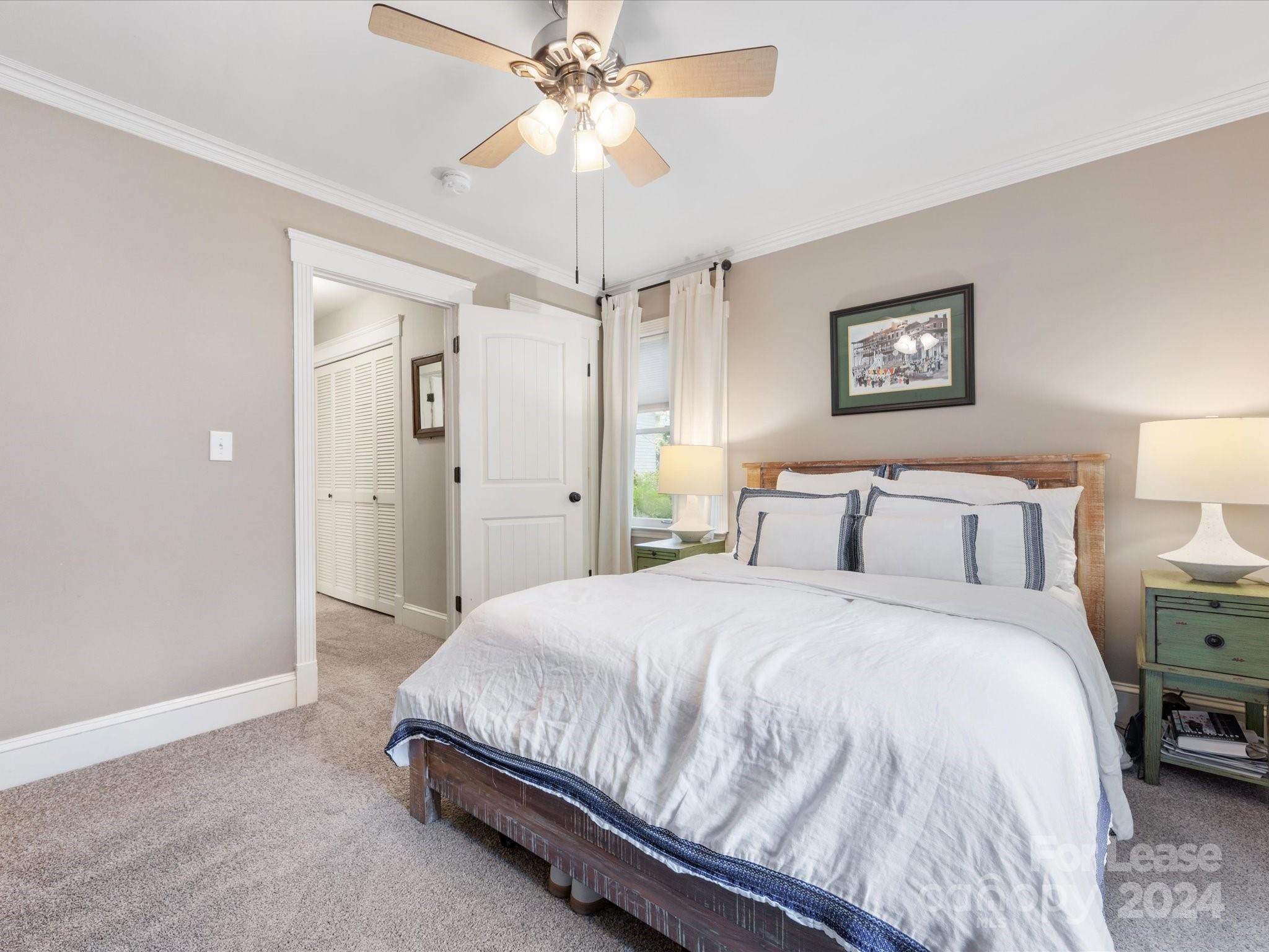 4411 Castleton Road Charlotte, NC 28211 - Photo 26 of 45 a spacious bedroom with a bed and a chandelier