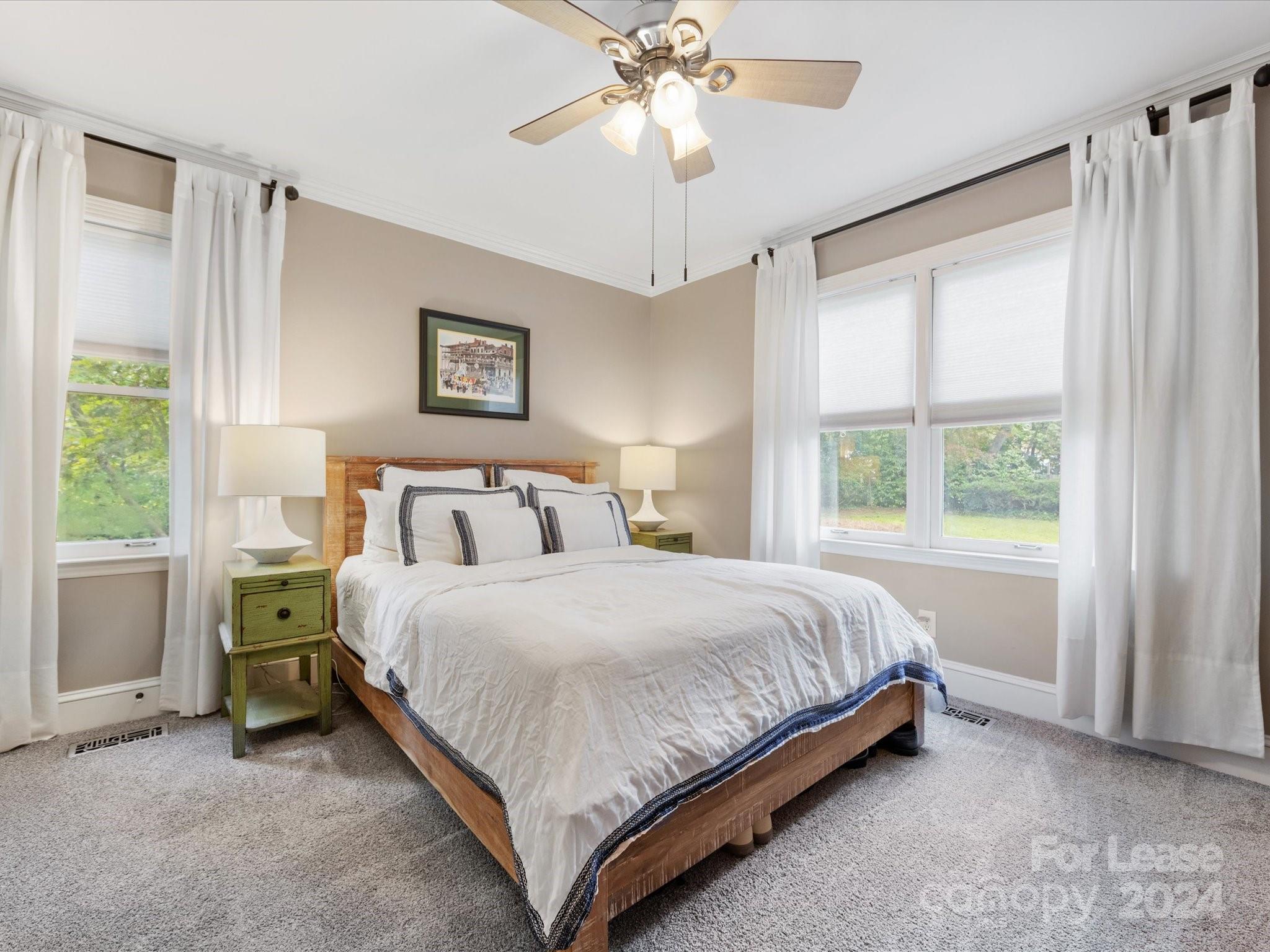 4411 Castleton Road Charlotte, NC 28211 - Photo 27 of 45 a bedroom with a bed and a chandelier