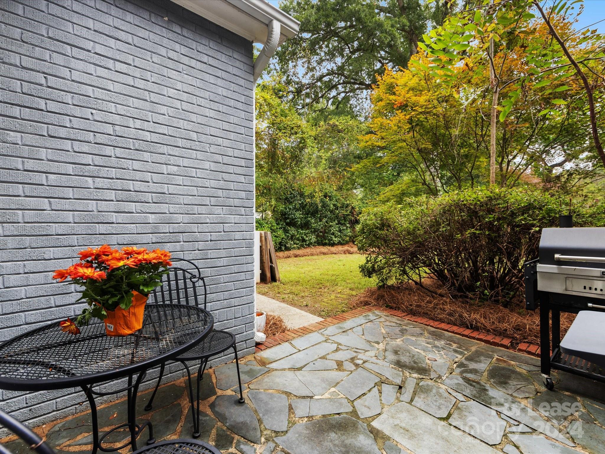 4411 Castleton Road Charlotte, NC 28211 - Photo 41 of 45 a view of a patio with table and chairs and potted plants