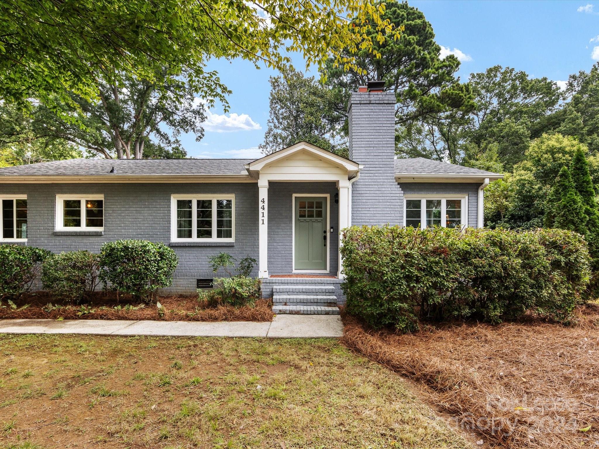 4411 Castleton Road Charlotte, NC 28211 - Photo 6 of 45 a front view of a house with a yard and potted plants