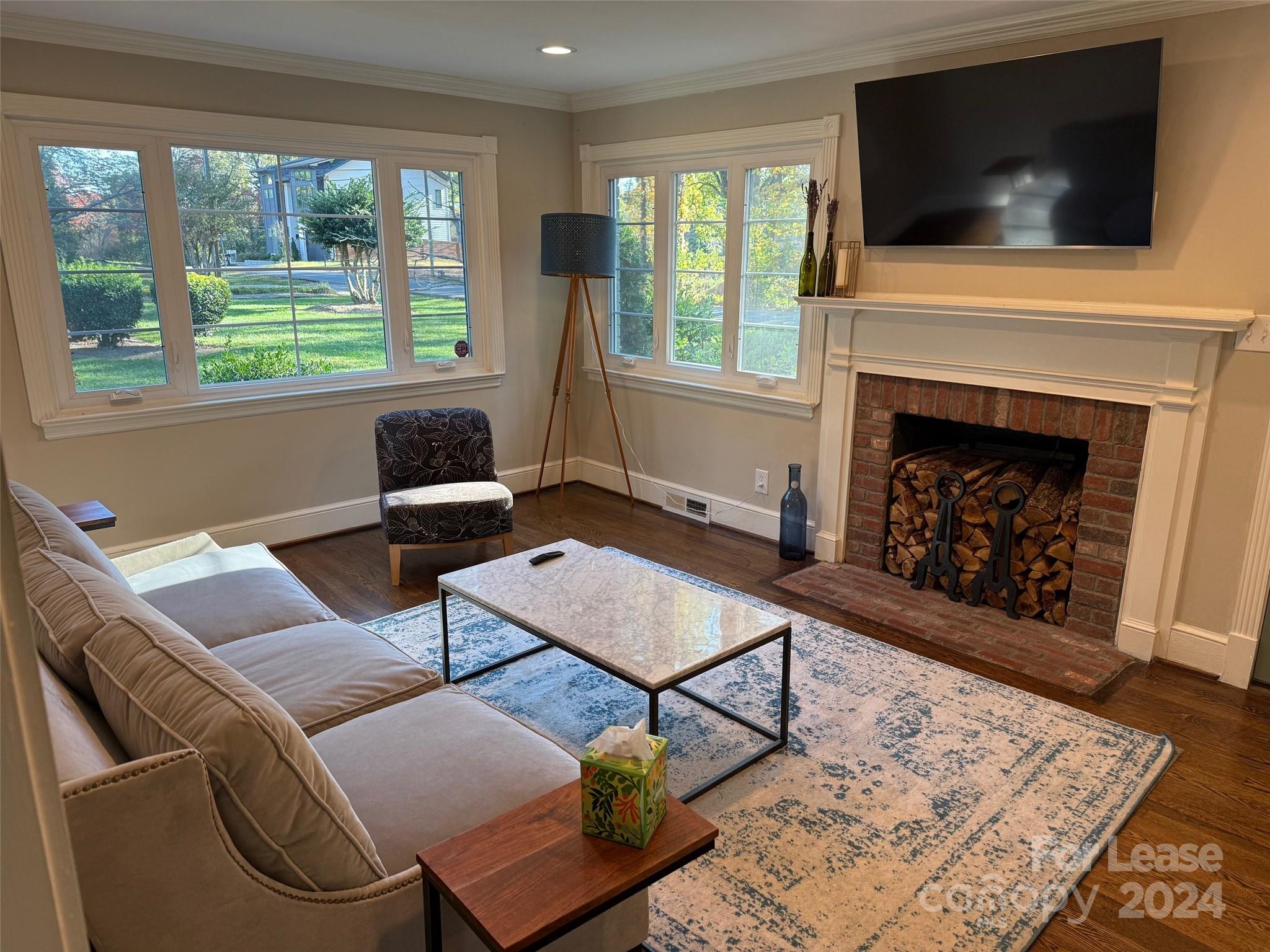 4411 Castleton Road Charlotte, NC 28211 - Photo 8 of 45 a living room with furniture a flat screen tv and a fireplace