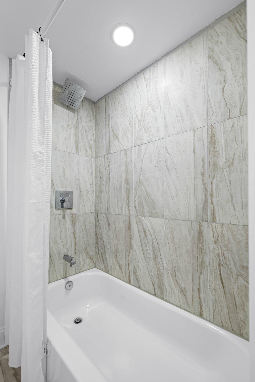 1225 Patapsco Street Baltimore, MD 21230 - Photo 17 of 21 a bathroom with a bathtub and a shower