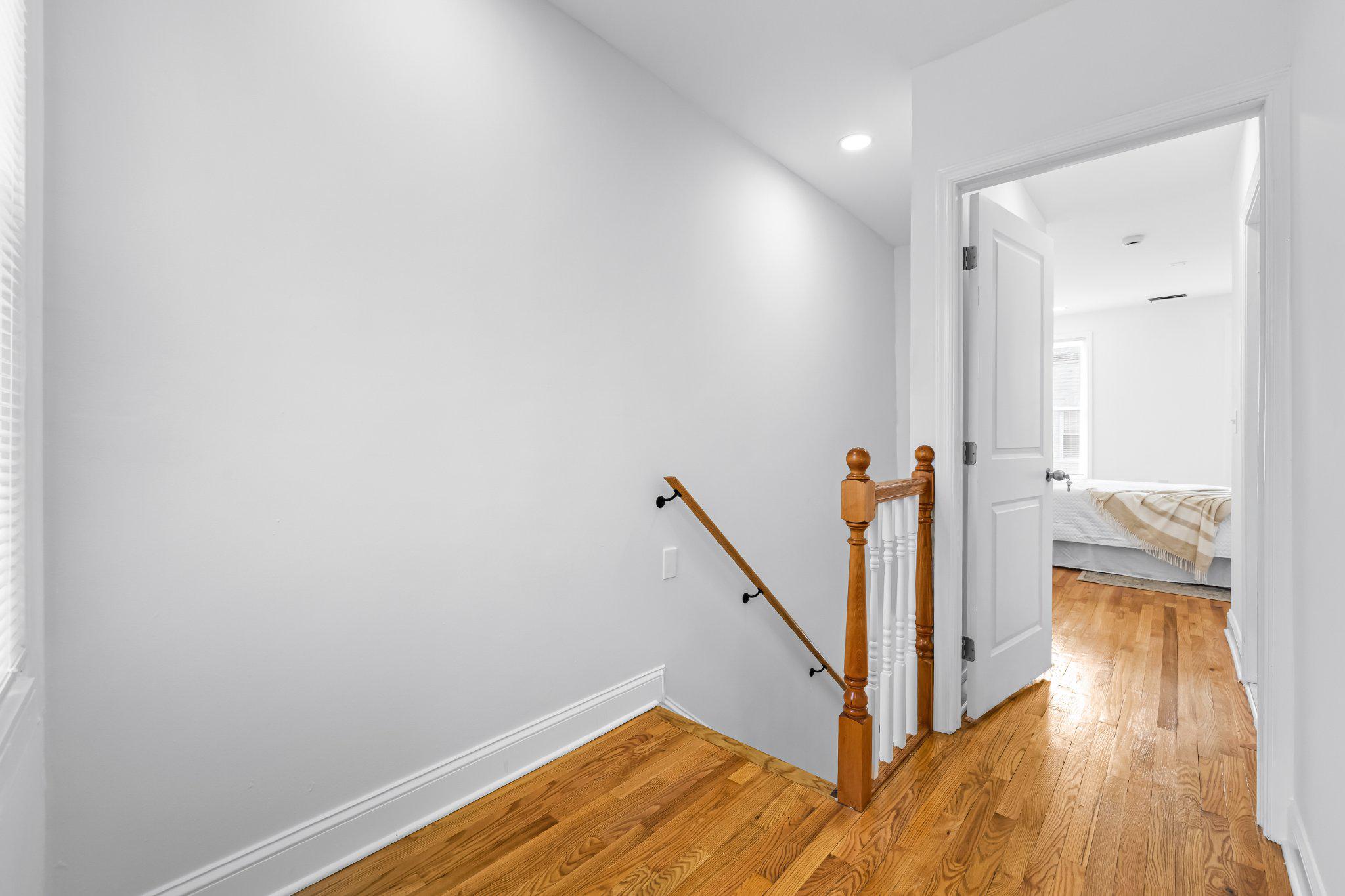 1225 Patapsco Street Baltimore, MD 21230 - Photo 10 of 21 a view of a hallway with wooden floor and staircase