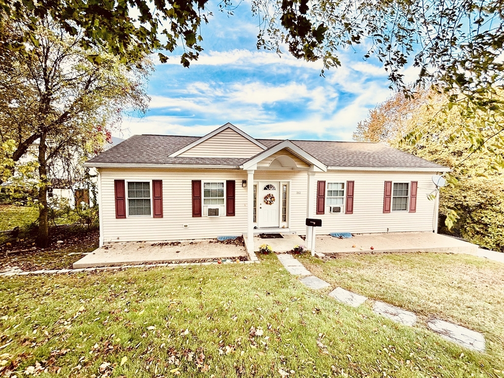 a front view of a house with a yard