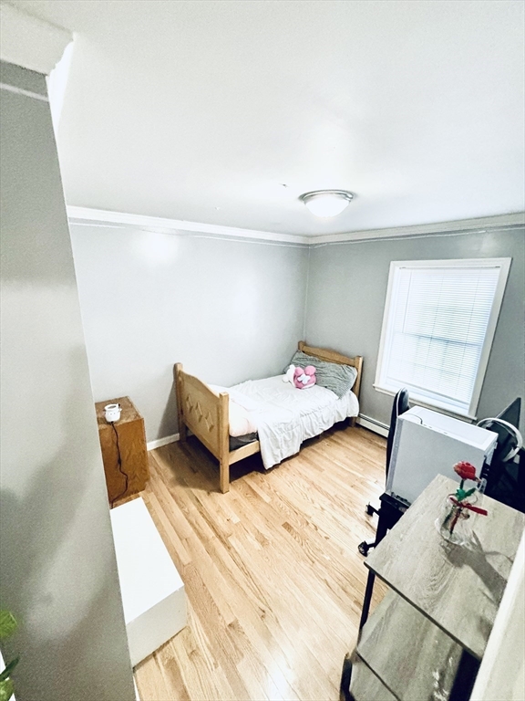 180 Beacon Street Clinton, MA 01510 - Photo 13 of 30 a bedroom with two beds and wooden floor