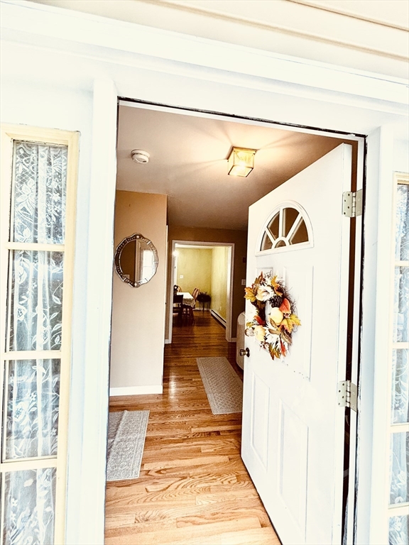180 Beacon Street Clinton, MA 01510 - Photo 3 of 30 a hallway with a dining table and chairs