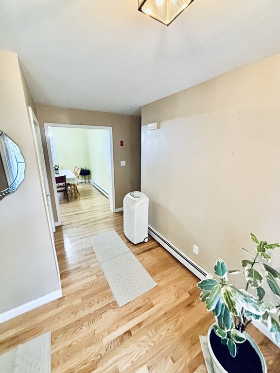 180 Beacon Street Clinton, MA 01510 - Photo 4 of 30 a bedroom with a bed and a potted plant