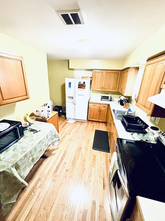 180 Beacon Street Clinton, MA 01510 - Photo 9 of 30 a bedroom with a bed and wooden floor