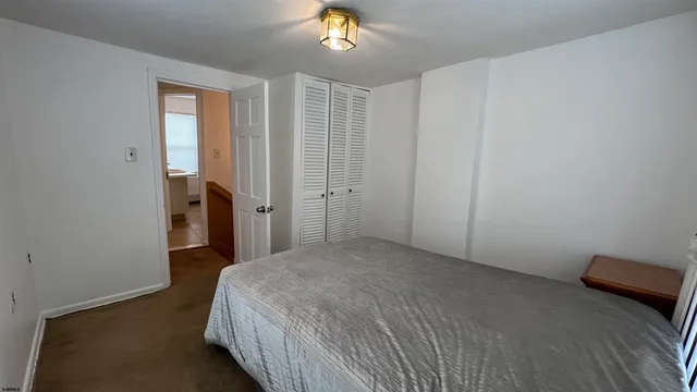 a spacious bedroom with a bed and a chandelier