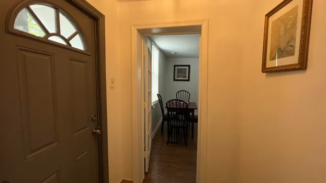 a view of hallway with wooden floor