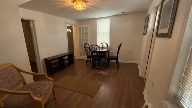 a dining room with furniture and window