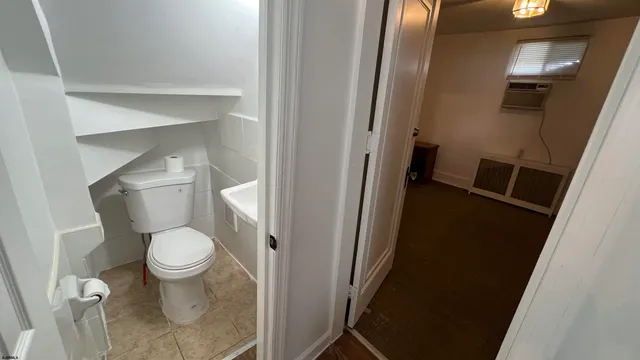 a white toilet sitting next to a sink