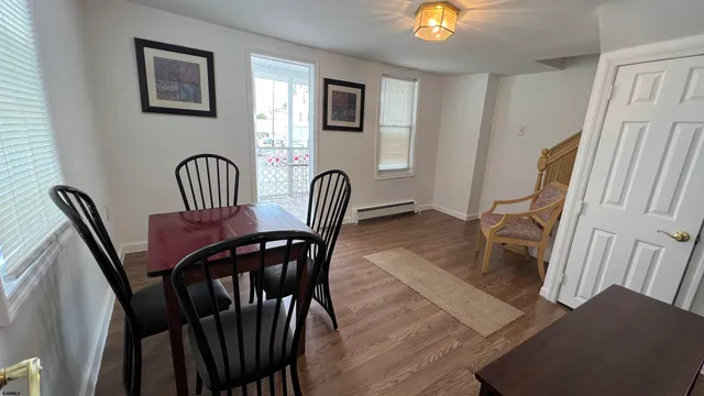 a view of a dining room with furniture and wooden floor