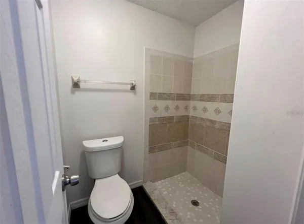 a bathroom with a toilet and a shower