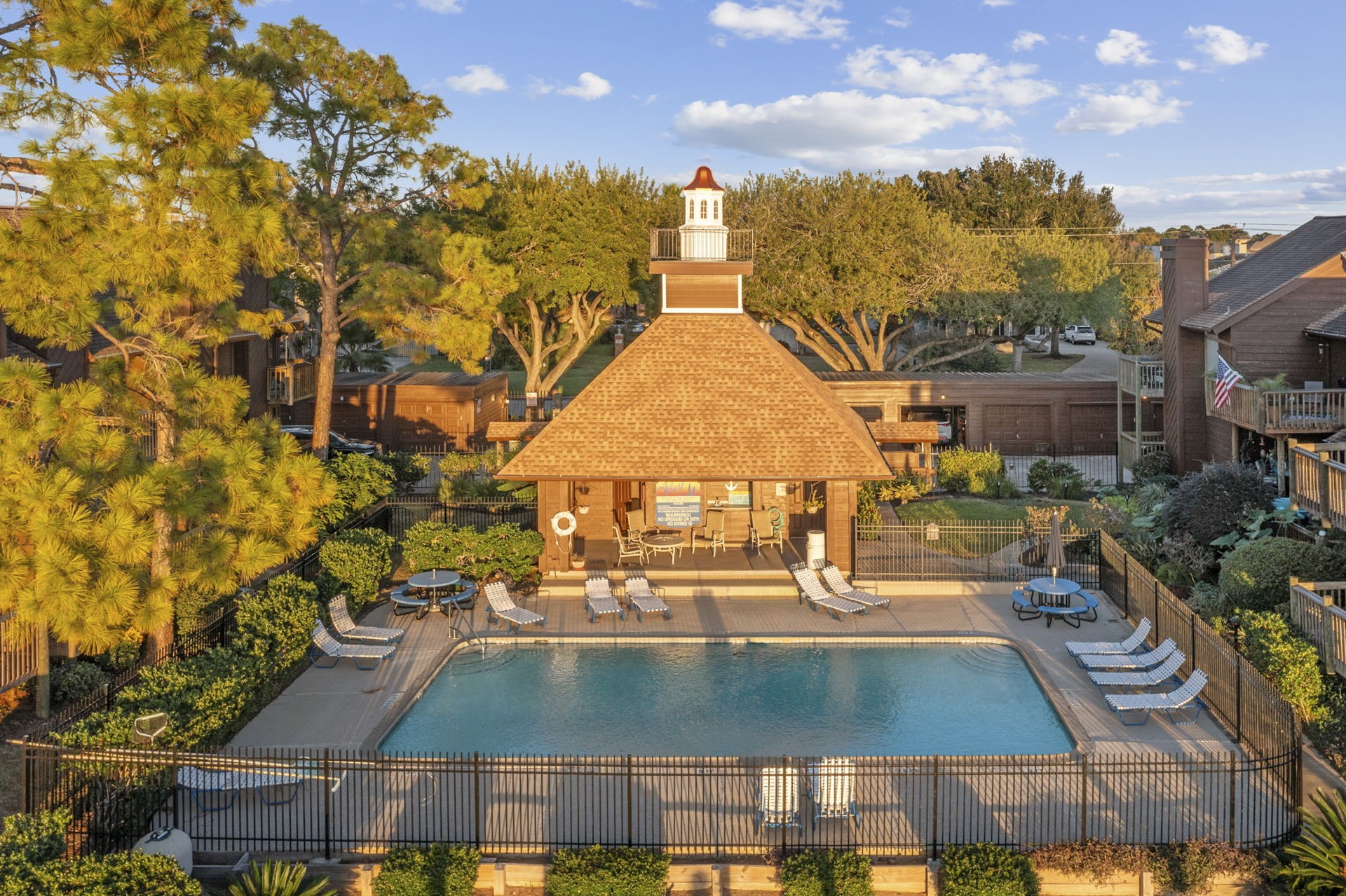 659 Davis Road League City, TX 77573 - Photo 27 of 34 a view of a swimming pool with a lawn chairs under an umbrella