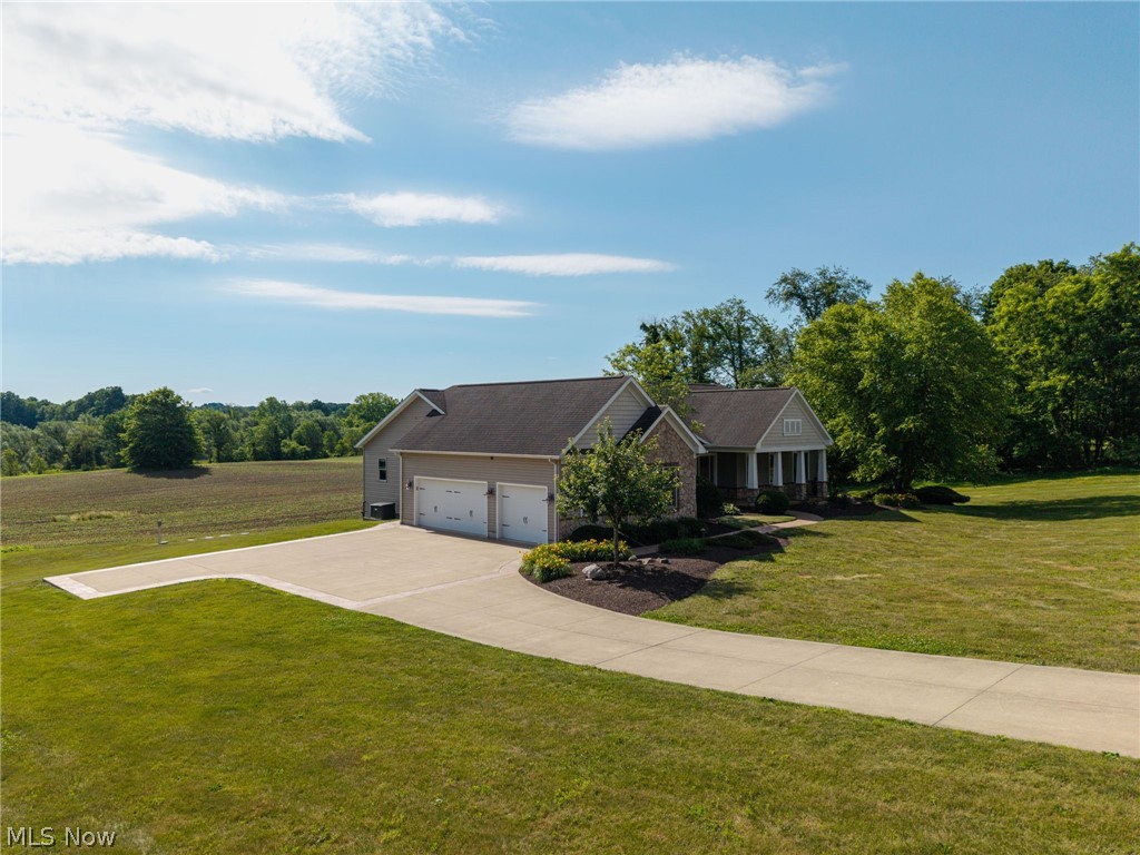 6925 River Styx Road Medina, OH 44256 - Photo 47 of 49 Ranch-style residence featuring a two-car garage, concrete driveway, and front porch with columns