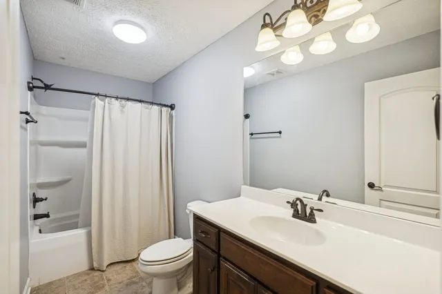 a bathroom with a double vanity sink and mirror