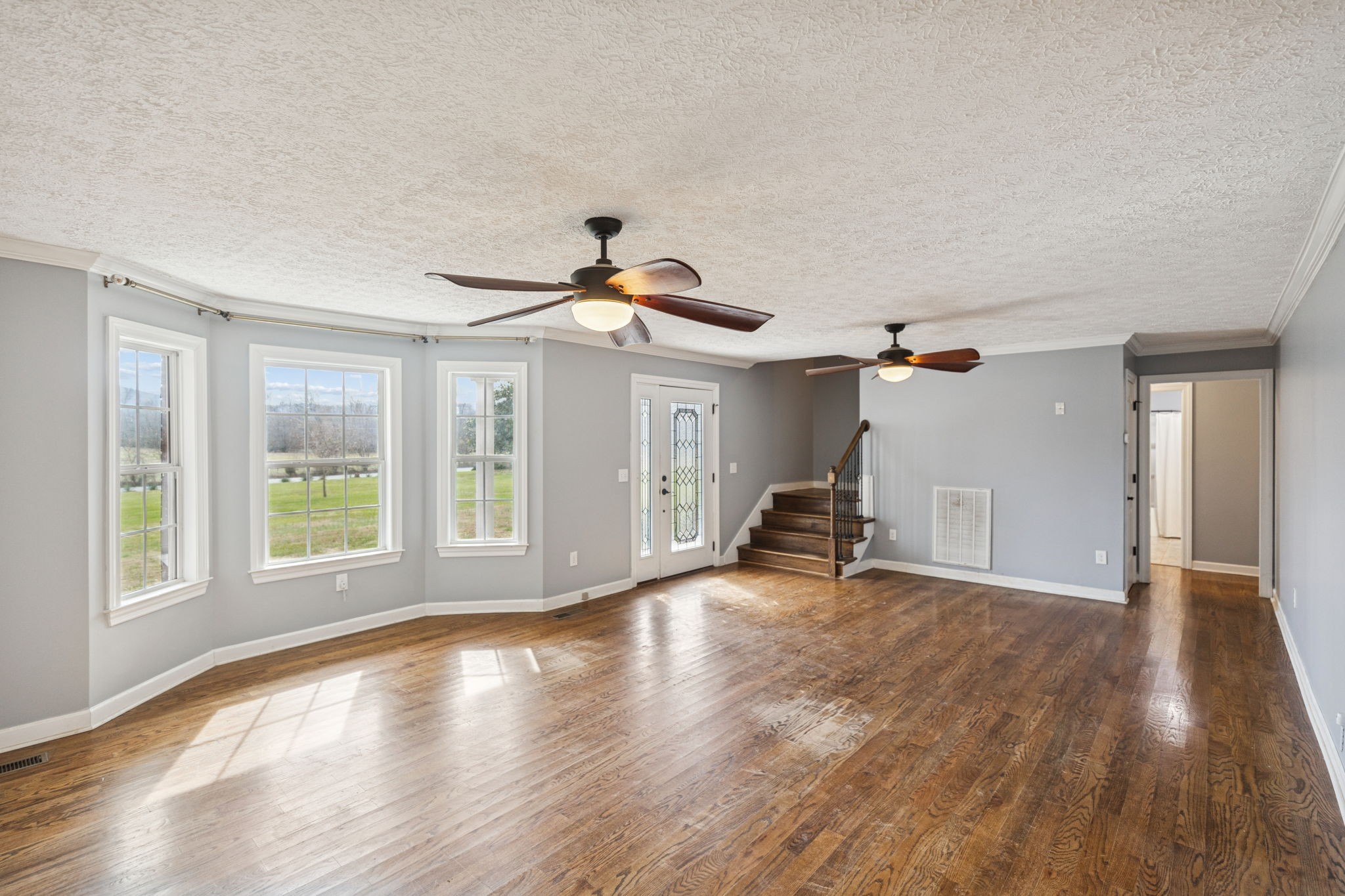 5453 Hillsboro Viola Road Manchester, TN 37355 - Photo 7 of 49 a view of empty room with wooden floor and fan