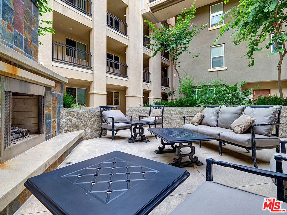 6020 South Seabluff Drive, Unit 122 Playa Vista, CA 90094 - Photo 24 of 33 a view of a patio with couches table and chairs with potted plants and a rug