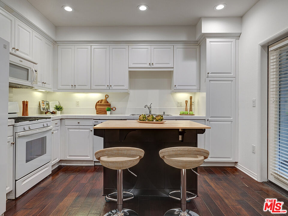 6020 South Seabluff Drive, Unit 122 Playa Vista, CA 90094 - Photo 8 of 33 a kitchen with a sink cabinets and wooden floor