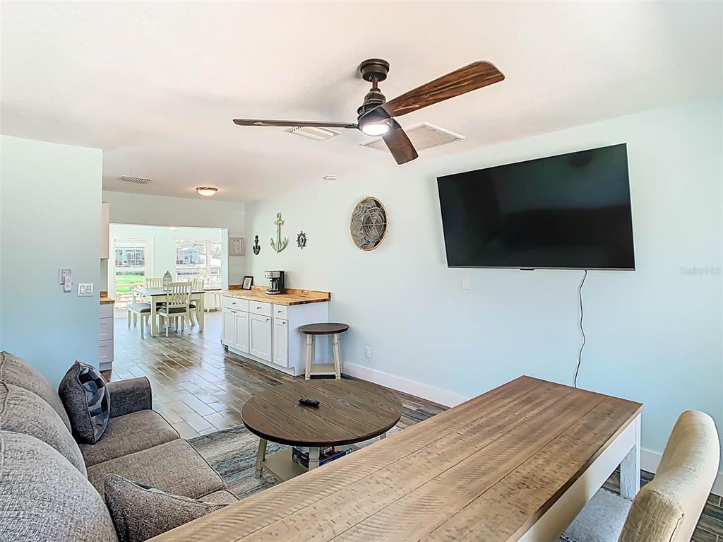 4984 Cedarbrook Lane Hernando Beach, FL 34607 - Photo 16 of 65 a living room with furniture and a flat screen tv