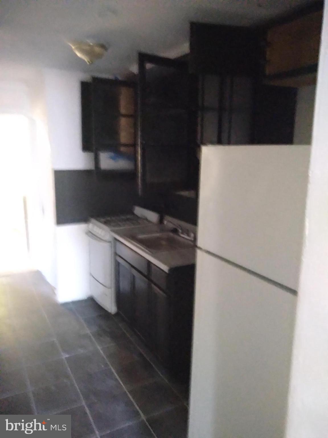 1205 30th Street Southeast Washington, DC 20019 - Photo 2 of 8 a white refrigerator freezer sitting inside of a kitchen