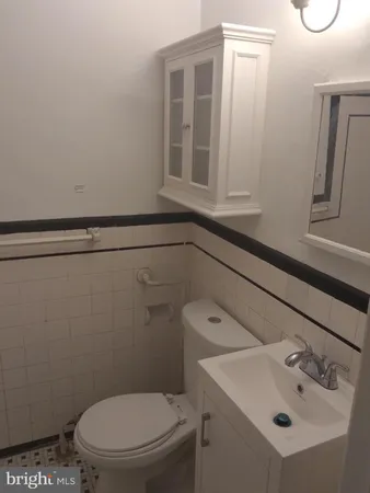a white toilet sitting next to a bathroom sink